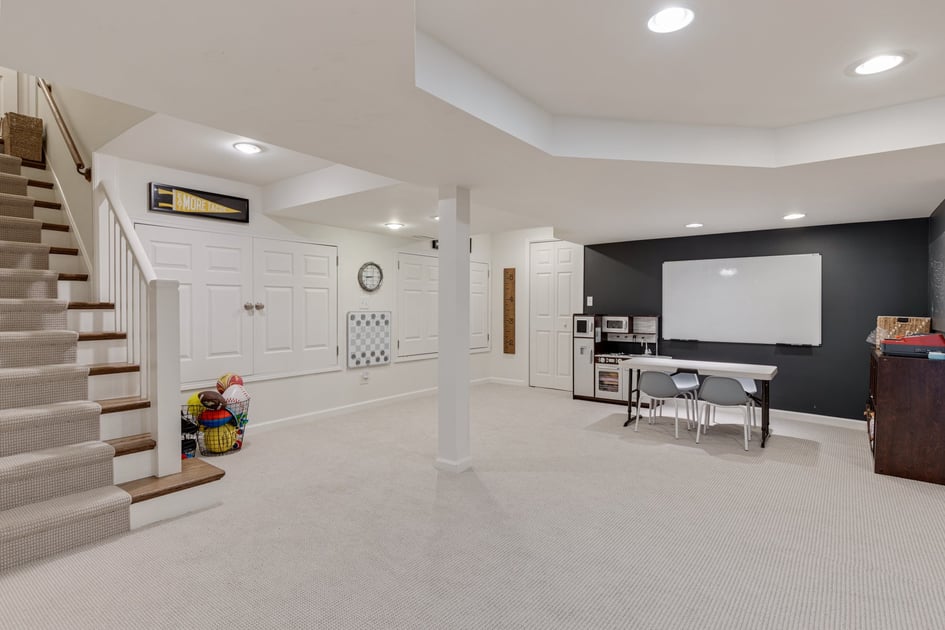 White painted basement ceiling with a home classroom
