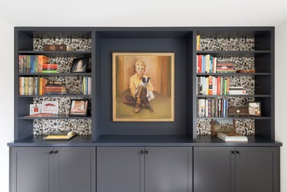 Home book shelf with a large portrait surrounded by books