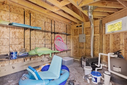 Unfinished backyard shed full of pool and water toys/inflatables