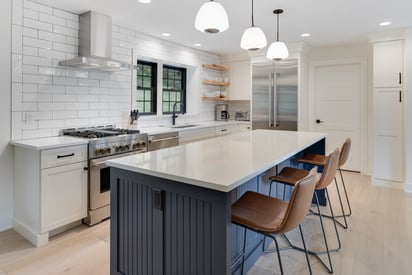 Kitchen island with 3 modern pendant lights and 3 minimalist bar chairs