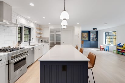 Kitchen island photo from the longer side with the pendant lights all hung in a straight line