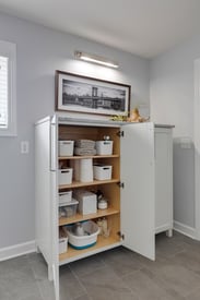 Built in shelf inside a shower with small white tile walls