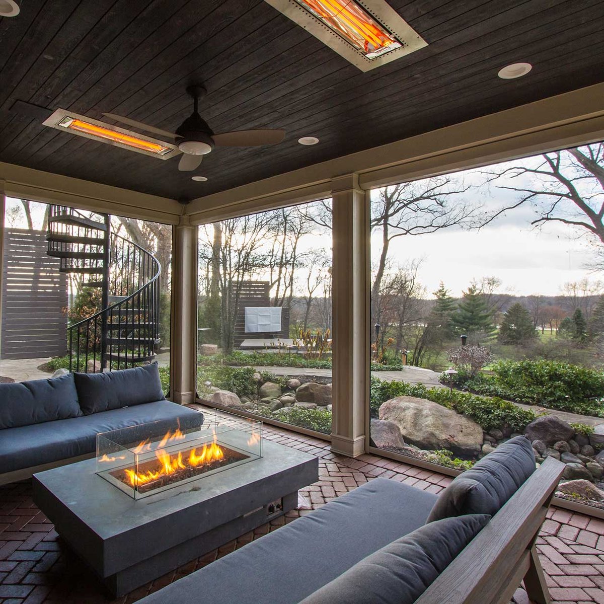 Outdoor fireplace with screened enclosure for relaxing during cold months