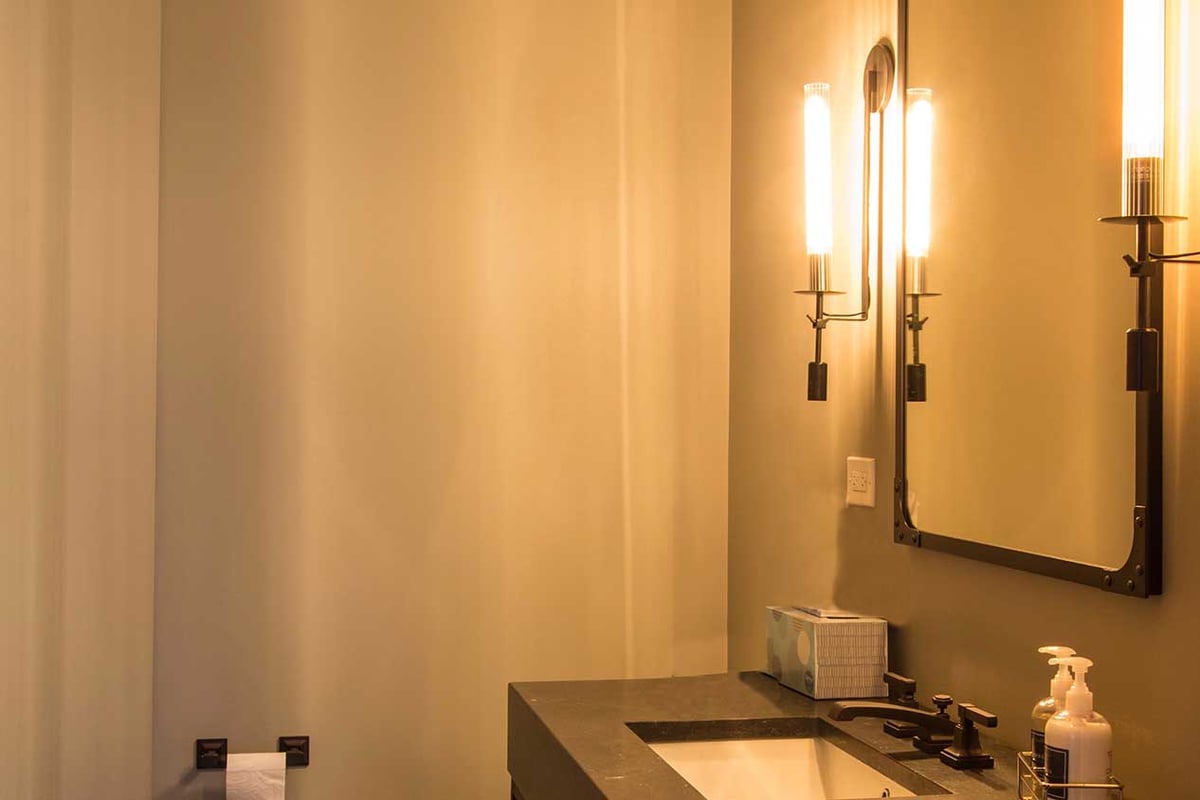 Bathroom vanity with dark granite and contrasting walls