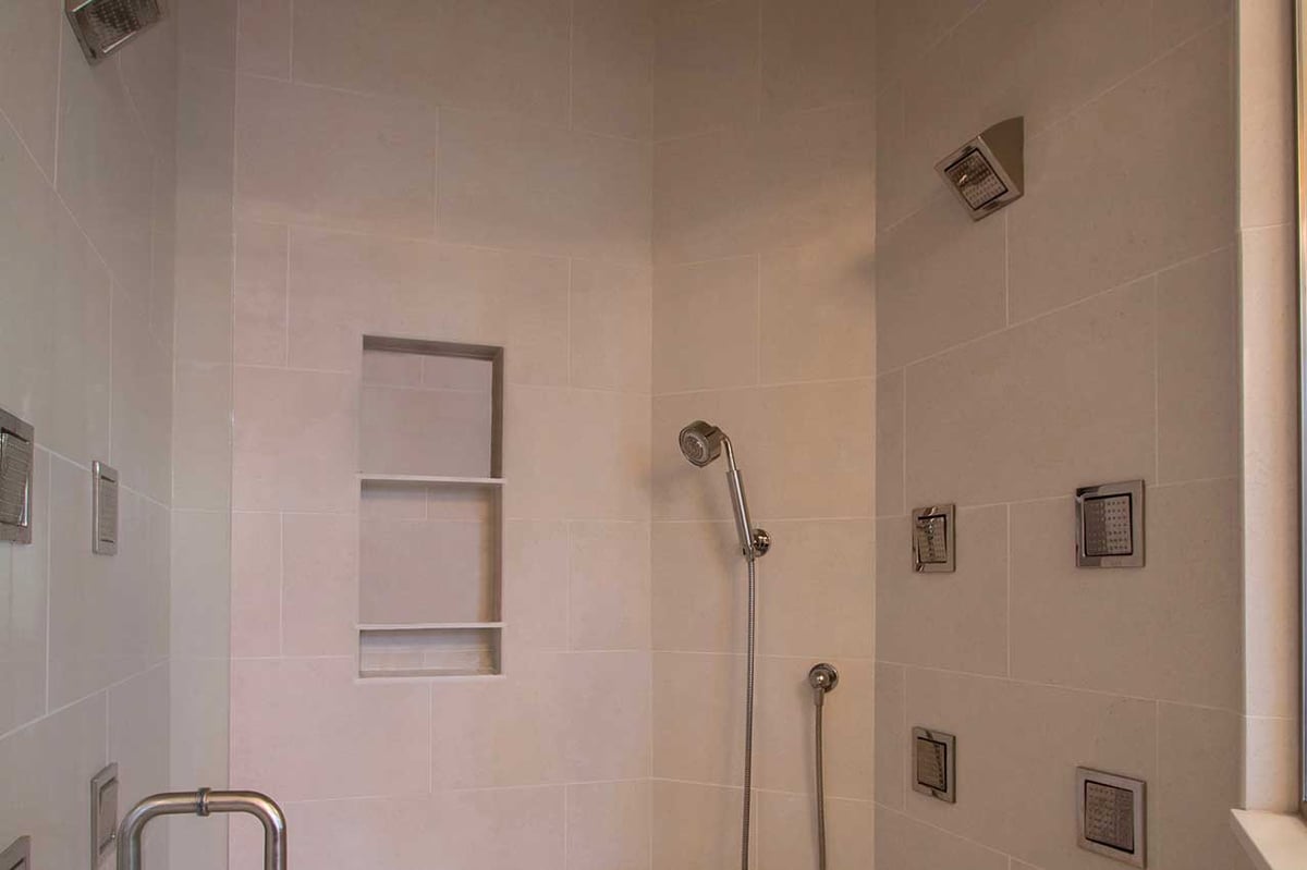 Stunning walk-in shower with chrome fittings and white tile