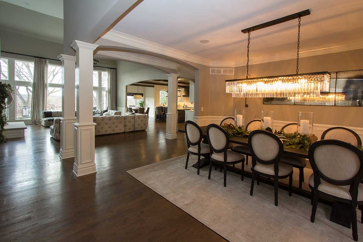 Large kitchen table with beautiful glass chandelier with seating for eight family members