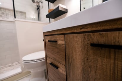 Close up photograph of a bathroom vanity with brushed black finishes