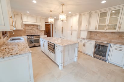 White, contemporary kitchen remodel with an island for seating and entertaining, lots of storage space, and a butler's pantry for extra storage.