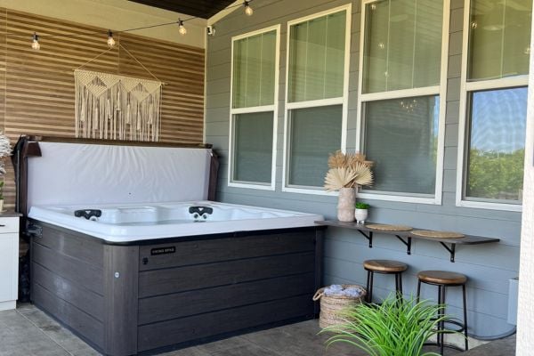 Open outdoor hot tub with wall mounted TV