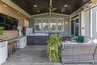 Outdoor porch with a roof over it that is connected to the house