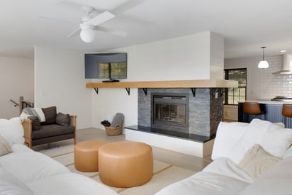 Living room with a large white sectional couch and natural wood trim