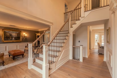 Foyer staircase leading up to the second story of a luxurious two-story home