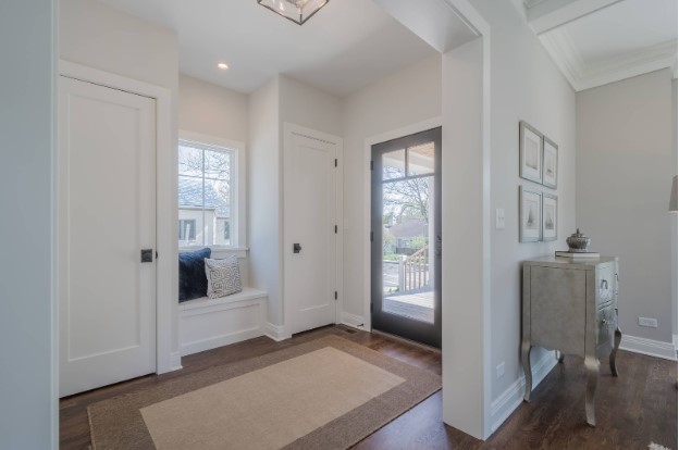 Indoor entryway with beige rug and glass door