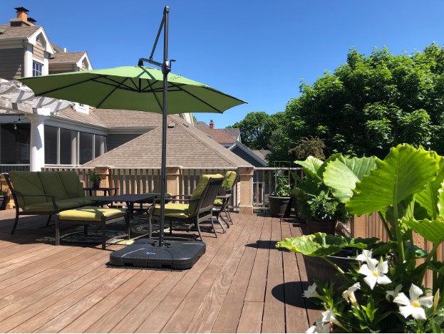 HDC outdoor living deck with green umbrella