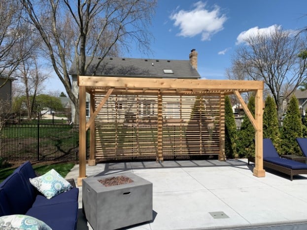 HDC pergola of wooden beams and blue seating