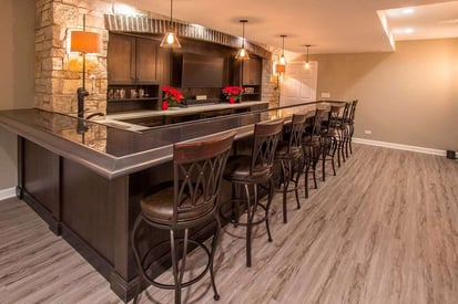 Long basement wet bar with an l-shaped countertop