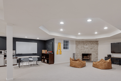 Wide angle photo of a basement with lots of space to play and entertain