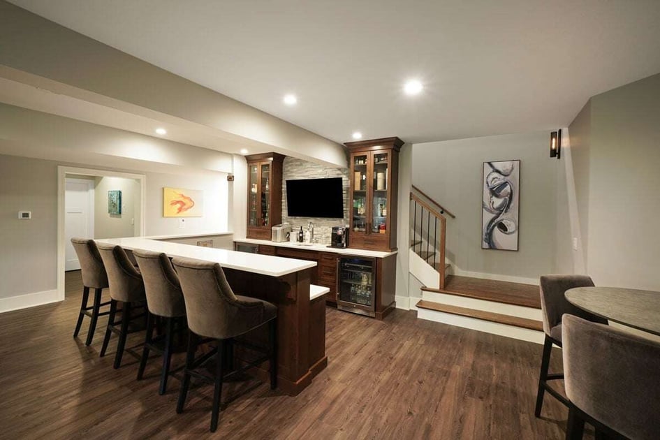 Long bar with seating stools in a home basement