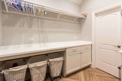 Laundry room with lots of storage for clothes to be hung and hampers for dirty clothes