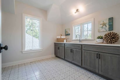 Bathroom with a single vanity, but no mirror and lots of glass pane windows for natural light