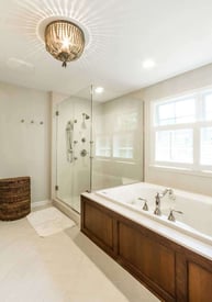 Elegant and luxurious master bathroom with a corner walk-in shower and a built-in tub