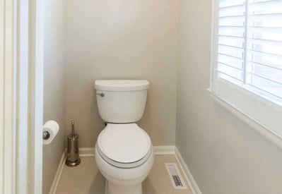 Toilet separate from the shower with privacy and a small window for light