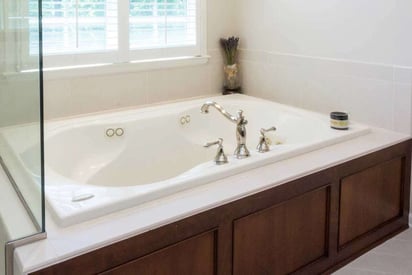 jet/jacuzzi tub with water jets and gold fixtures