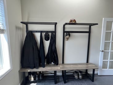 Coatrack and shoe shelf in the mudroom of a corporate office