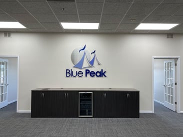 Blue Peak Tents logo on the wall of a meeting room