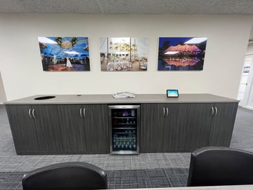 Side table with built in cabinets and a mini fridge for corporate meetings