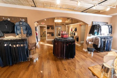 Multiple displays of clothes can be seen on the walls and on the floor of this store