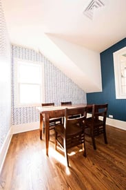 Small seating sun room with a dining table that seats four