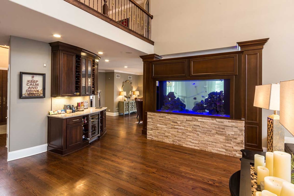 Living room with fish tank accent and stone wall paneling