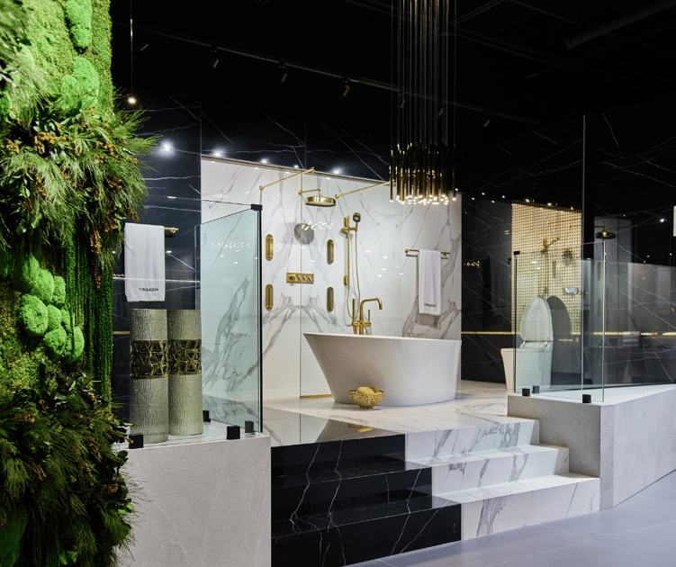 Luxury bathroom tile showroom with a stand alone tub and gold fixtures