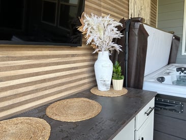 Outdoor dry bar with some added storage and a hot tub in the background