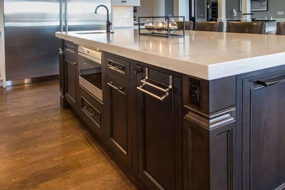 kitchen sink built into the kitchen island with lots of pull out drawers and cabinets for storage space