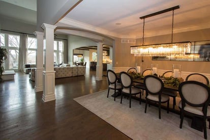 Spacious and warm dining room with 8 chairs and a statement chandelier