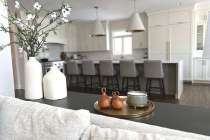 runner table placed against the back of the living room sofa with the kitchen in the background