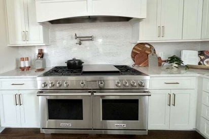 side-by-side kitchen over/stove with an exhaust fan above the range