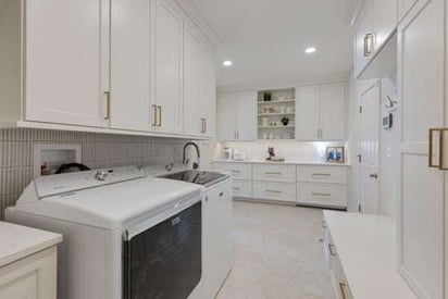 laundry room with side-by-side top load washer and dryer on the left side of the room