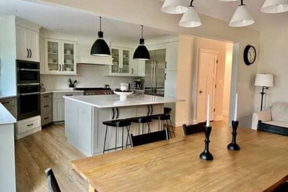 dining room table with black candle holders on top with tall white candle wicks sticking out