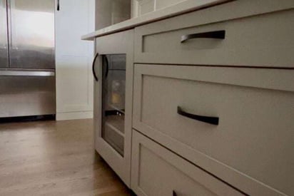 Close up of a wine cooler built into a kitchen island