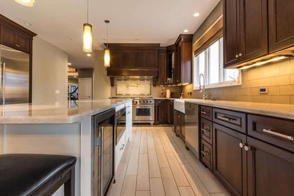 Kitchen cabinets with brown stain and silver finishes