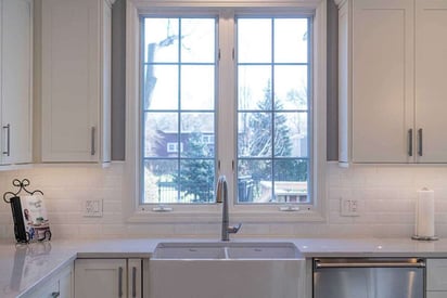 Kitchen sink with a large bi-fold window behind it to let lots of natural light fill the space