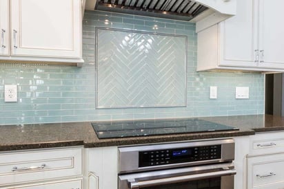 Teal ceramic tile backsplash with an electric stove top oven