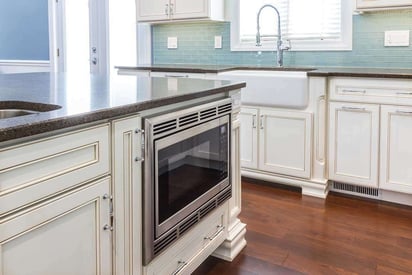 Microwave oven built into a kitchen island for easy use and prep when cooking at home