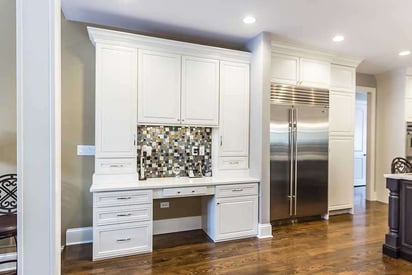 side butler's pantry attached to the kitchen with a ceramic colorful tile backsplash