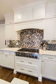 kitchen oven with white cabinetry frame that it sits inside of