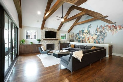 Family room with a wall mounted TV, and large fireplace, and patio doors for a seamless transition between the indoors and outdoors