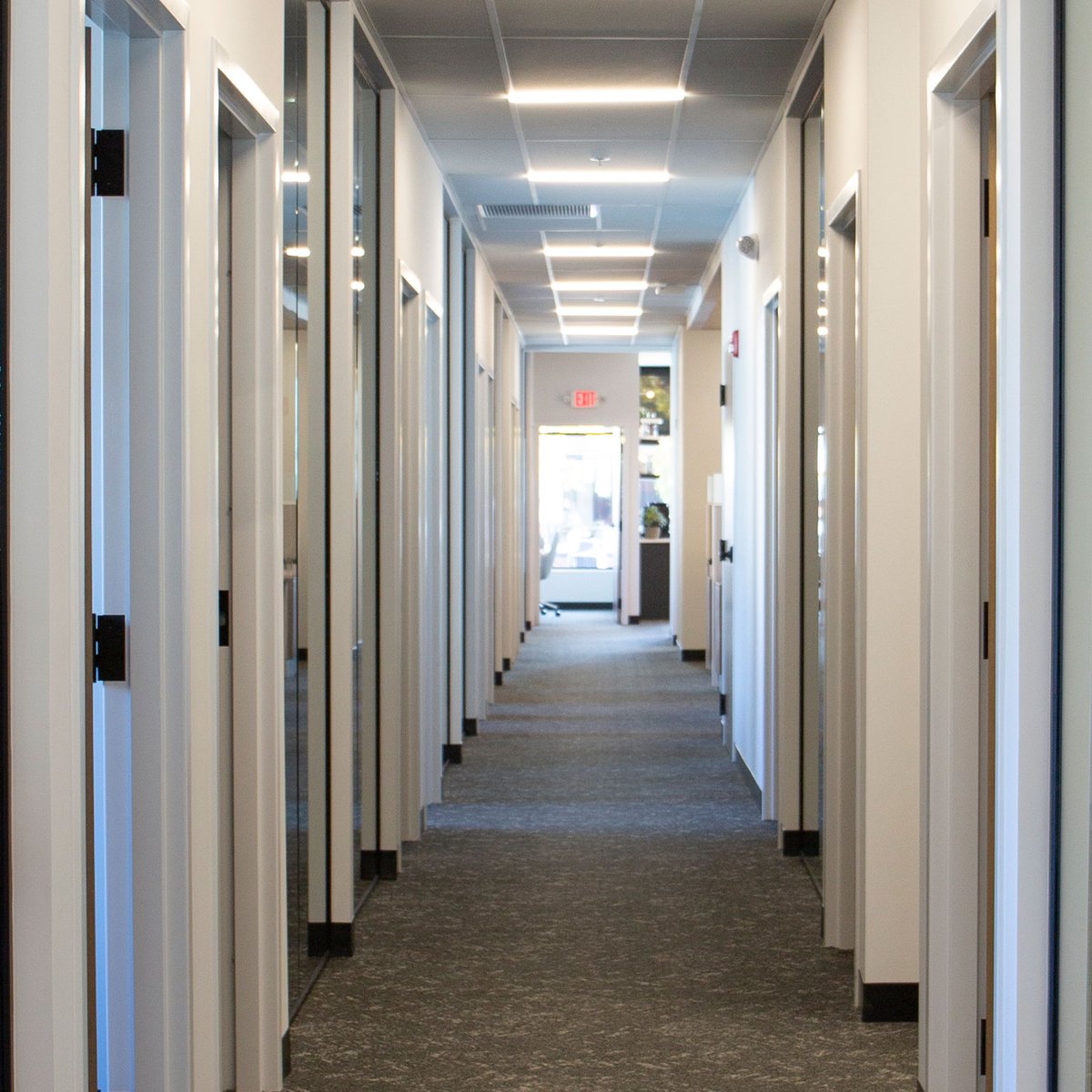 Hallway at a business with doors on the left and right